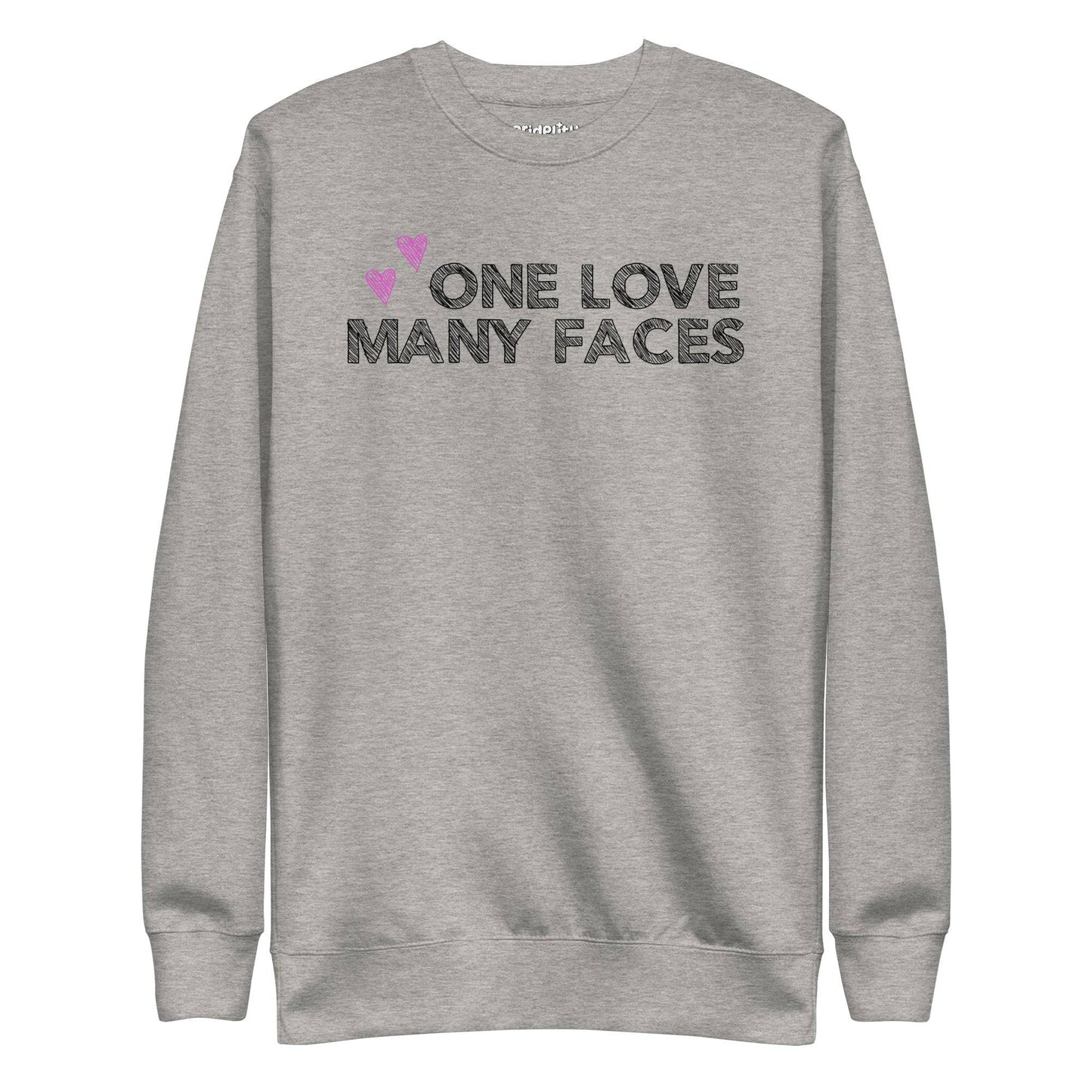 A carbon grey One Love Sweatshirt from Pridelity's pride collection features the text "ONE LOVE MANY FACES" in black, accented by two pink hearts above.