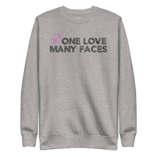 A carbon grey One Love Sweatshirt from Pridelity's pride collection features the text "ONE LOVE MANY FACES" in black, accented by two pink hearts above.