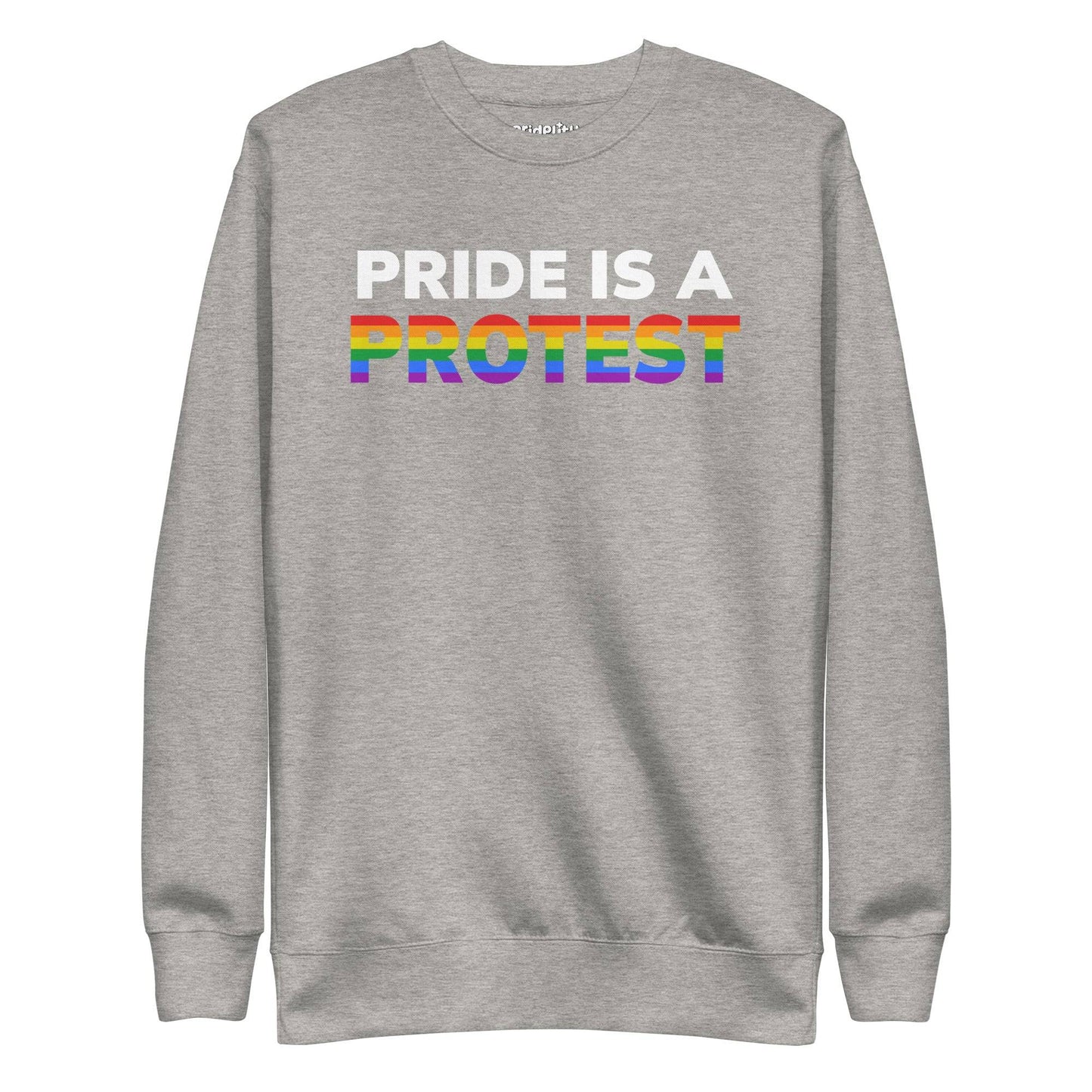 Introducing the "Pride is a Protest" Sweatshirt by Pridelity. This black sweatshirt prominently displays the message "Pride is a Protest," with the word "Protest" shining in vibrant rainbow colors, capturing the essence of the LGBTQ+ pride flag. It’s an ideal choice for any pride outfit and a highlight of our pride collection.