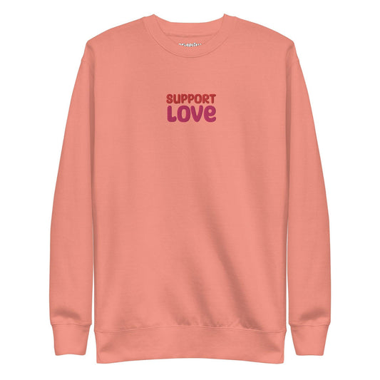 Dusty rose sweatshirt from Pridelity featuring "SUPPORT LOVE" in bold, purple lettering on the front. As part of our pride collection, this simple yet central design makes a proud statement.