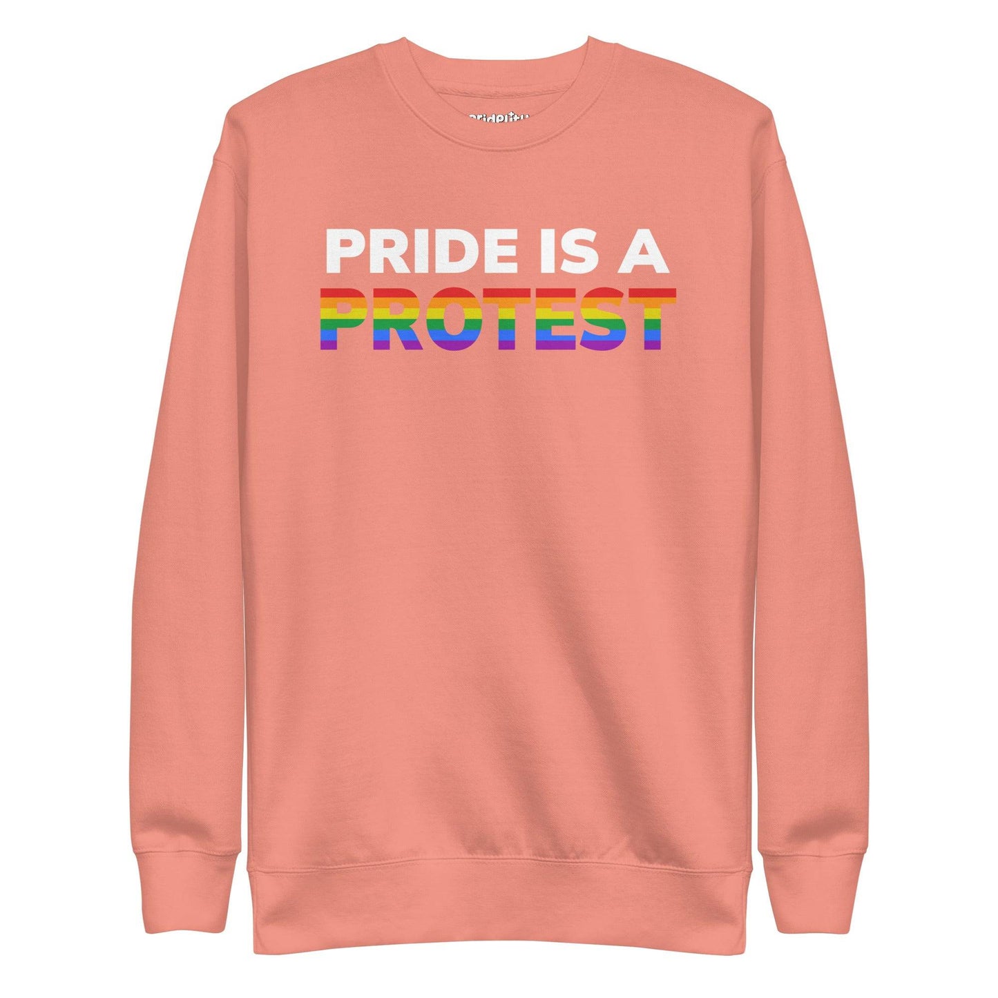 Introducing the "Pride is a Protest" Sweatshirt by Pridelity. This black sweatshirt prominently displays the message "Pride is a Protest," with the word "Protest" shining in vibrant rainbow colors, capturing the essence of the LGBTQ+ pride flag. It’s an ideal choice for any pride outfit and a highlight of our pride collection.