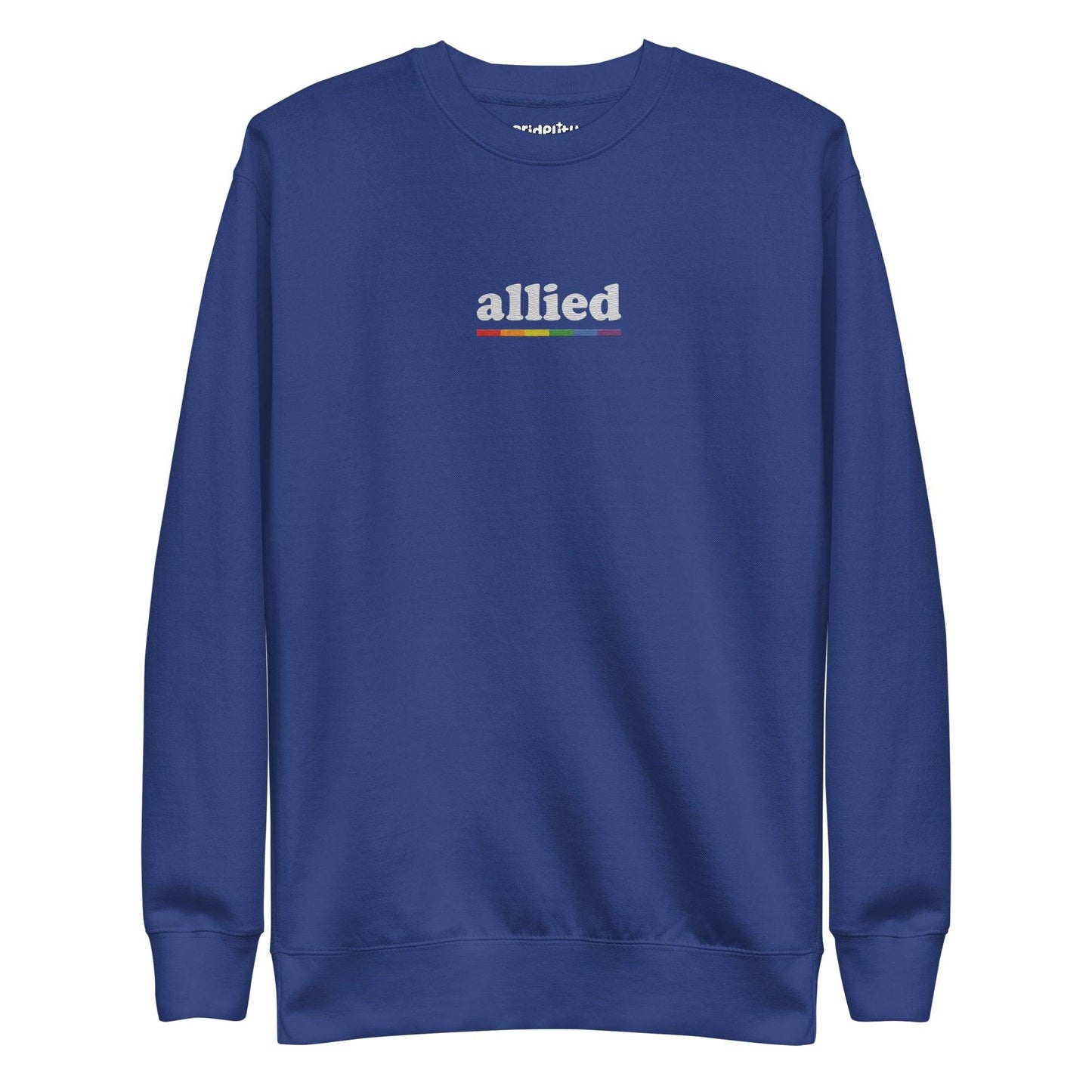 This Allied Sweatshirt by Pridelity, from our Pride Collection, showcases the word "allied" in lowercase letters. Beneath it is a multi-colored horizontal line in shades of gray, blue, yellow, black, and red to honor diversity. The look is finished with a classic crew neck for timeless style.