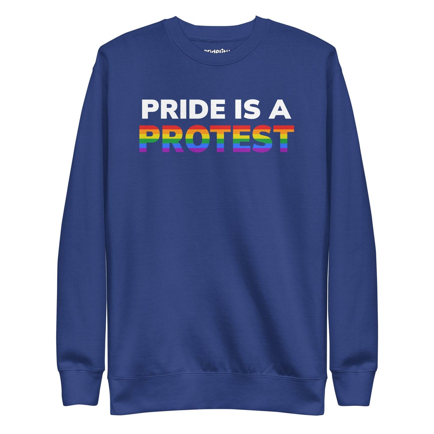 Introducing the "Pride is a Protest" Sweatshirt by Pridelity. This black sweatshirt prominently displays the message "Pride is a Protest," with the word "Protest" shining in vibrant rainbow colors, capturing the essence of the LGBTQ+ pride flag. It’s an ideal choice for any pride outfit and a highlight of our pride collection.