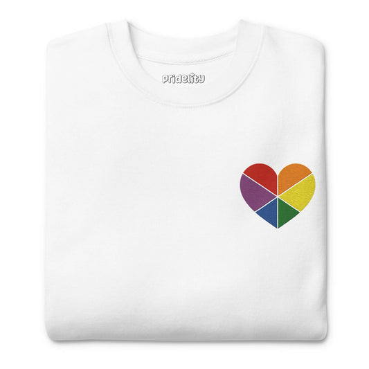 Introducing the Pride Heart Sweatshirt by Pridelity, a white sweatshirt from our pride collection. It showcases a small, multicolored heart graphic on the upper left chest. The heart is divided into sections with rainbow colors, making it an ideal staple for your pride outfit.