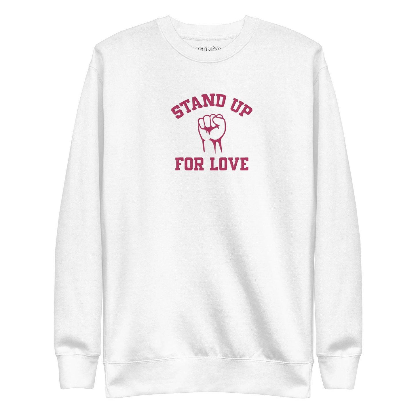 A folded white Pridelity Stand Up Sweatshirt showcases the phrase "STAND UP FOR LOVE" in red, encircling a striking graphic of a raised fist, making it a distinctive addition to any pride collection.
