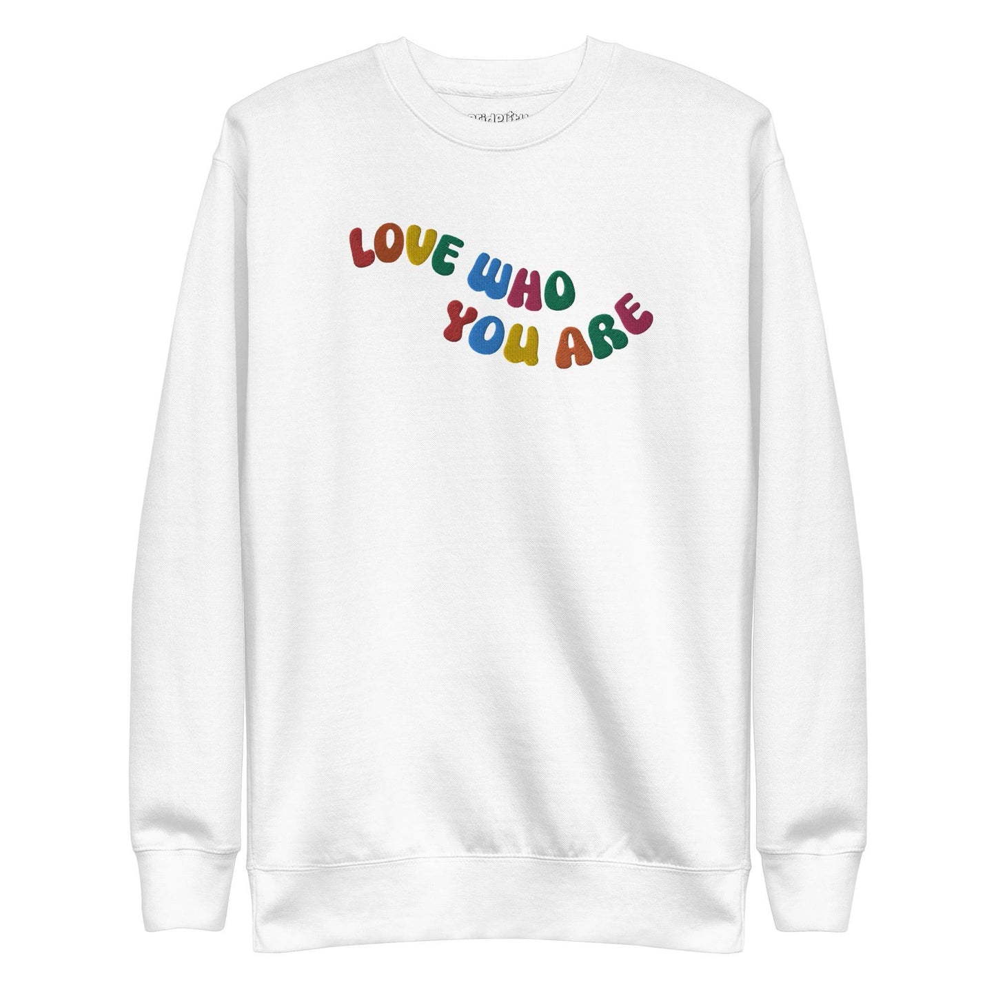 A black sweatshirt, neatly folded, prominently features the "LOVE WHO YOU ARE" message in bold, vibrant letters reminiscent of rainbow attire, with the brand name "Pridelity" elegantly displayed at the top.