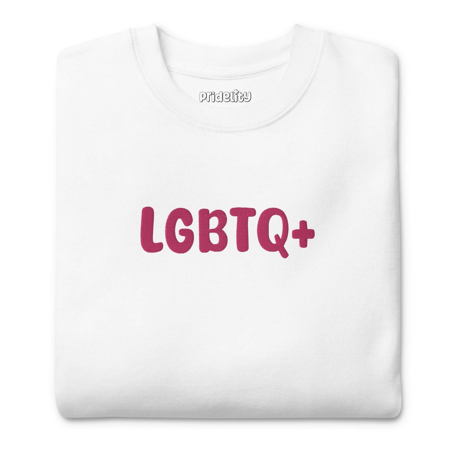 A Pridelity LGBTQ+ Sweatshirt in white, adorned with bold pink "LGBTQ+" lettering on the front, is perfect for embracing your pride with flair and aligns beautifully with the vibrant essence of rainbow apparel.