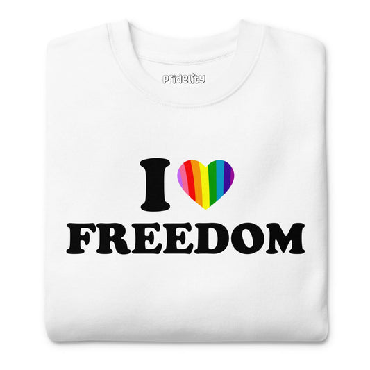 Introducing the I Love Freedom Sweatshirt by Pridelity, a stylish white garment adorned with the phrase "I ♥ FREEDOM," where the heart symbol is vividly colored in rainbow hues—a must-have for fans of rainbow-themed apparel.