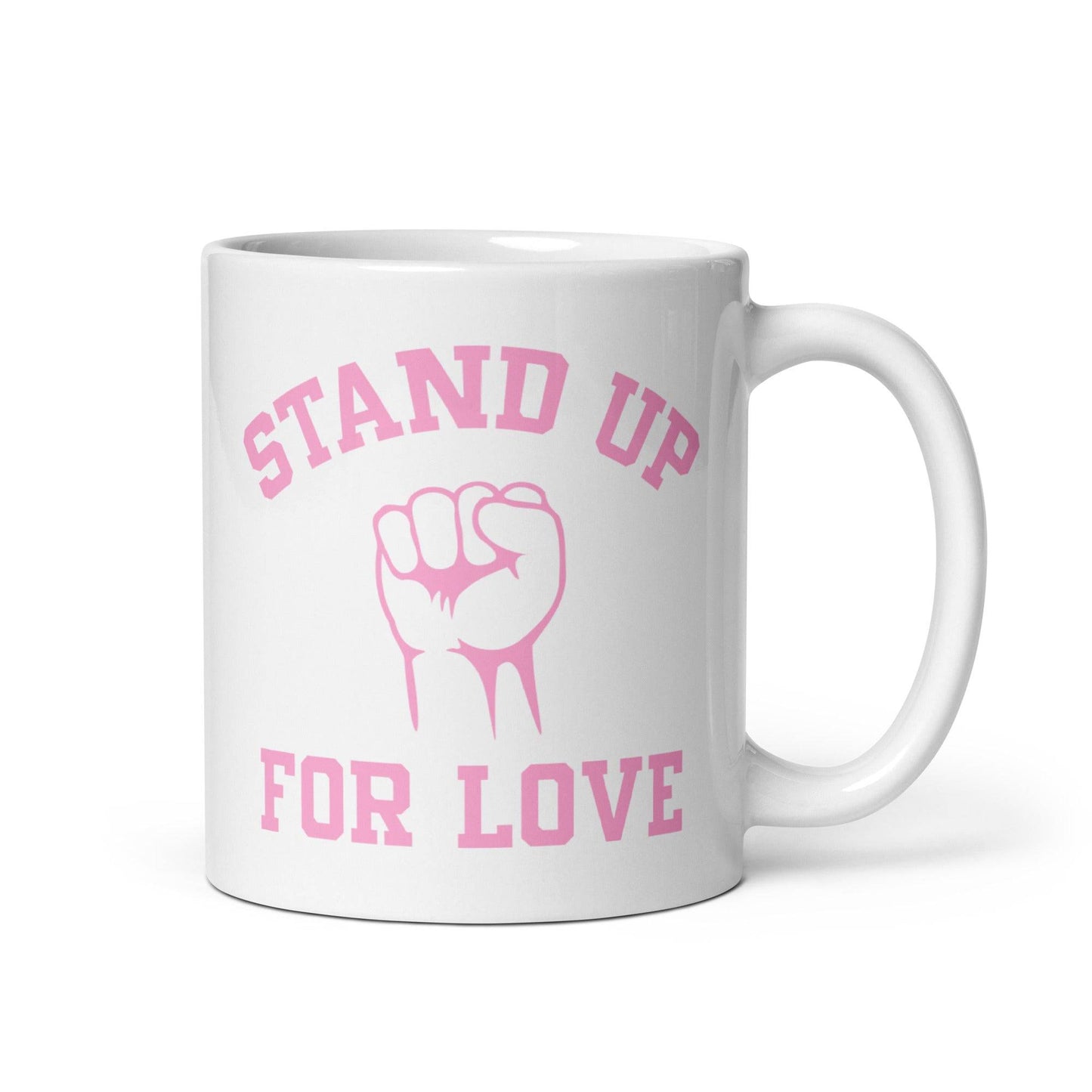 The "Stand Up For Love" mug from Pridelity features pink text on a white background, reading "Stand Up for Love," with an image of a raised fist between the words. As part of the Pride Collections 2025, it symbolizes unity and love.