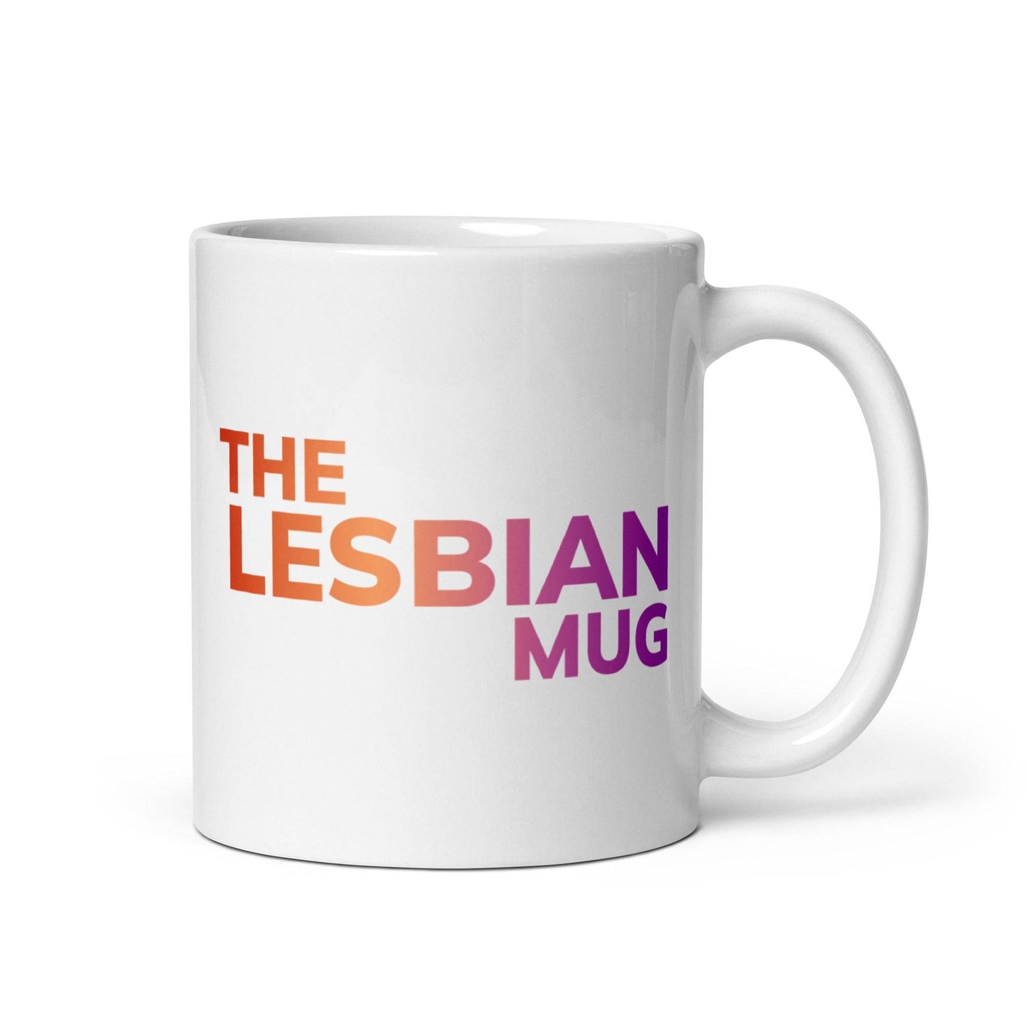 The Pridelity "The Lesbian Mug" is a stylish white ceramic mug featuring the phrase "THE LESBIAN MUG" in a striking gradient from orange to purple, prominently displayed at its center. A proud addition to the pride collections of 2025, it celebrates identity with flair.
