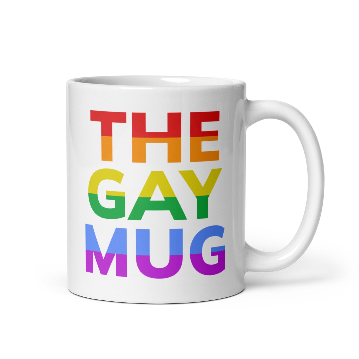 A product from Pridelity, The Gay Mug, is a white mug from the Pride Collections 2025 series featuring "THE GAY MUG" in bold letters. Each word radiates in a different shade of the LGBTQ+ pride rainbow: red, orange, yellow, green, blue, and purple.