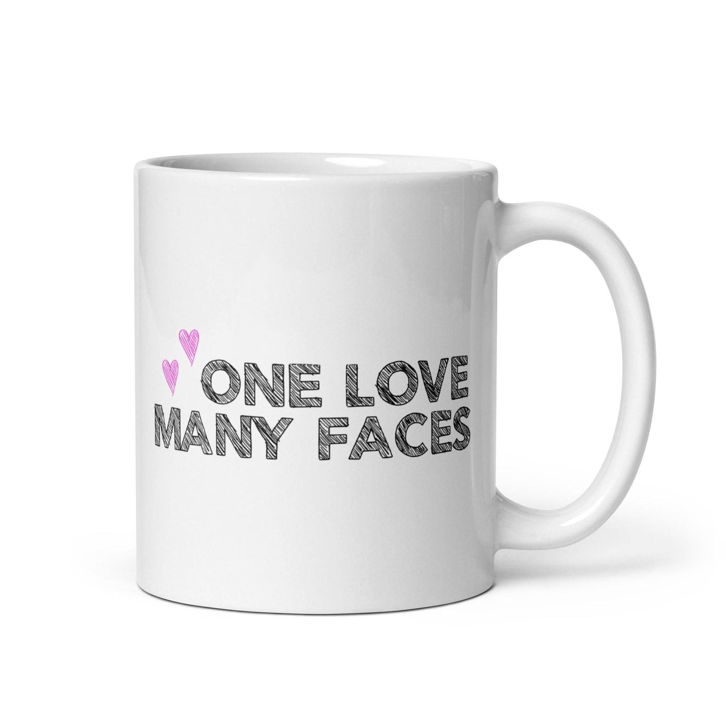The One Love Many Faces Mug by Pridelity, part of the Pride Collections 2025, showcases the phrase "One Love Many Faces" in bold black letters. It is adorned with two small pink hearts on the left side above the text, all set against a plain white background to celebrate unity and diversity.