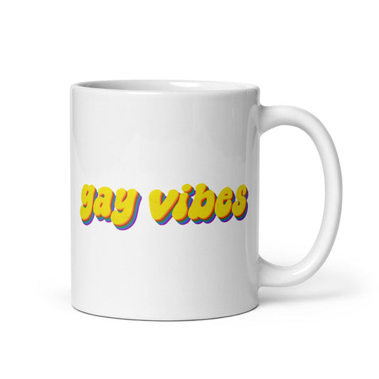 The Gay Vibes Mug by Pridelity, featuring bold yellow "gay vibes" text with a shadow effect on a white background, is included in the best pride collections of 2025.