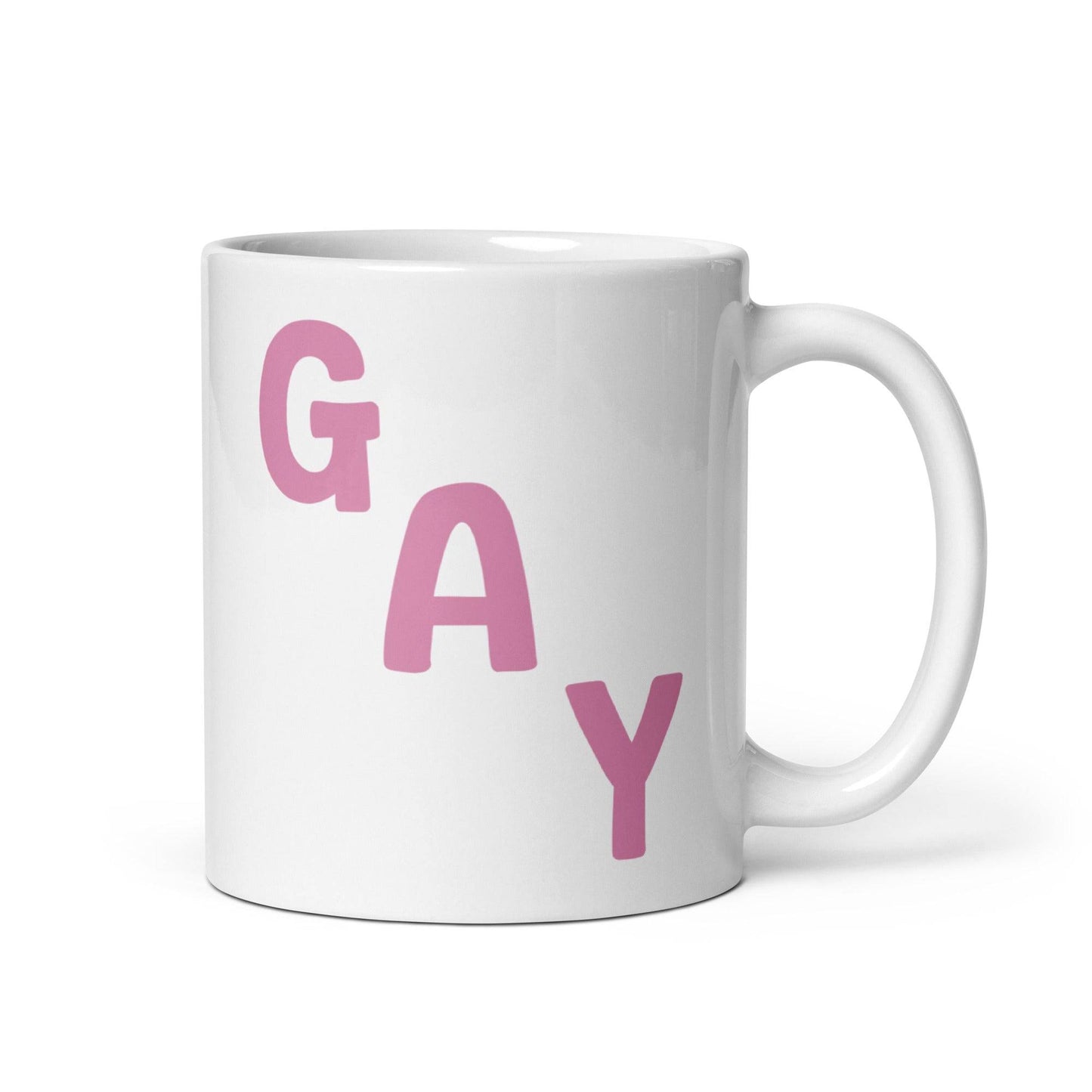 This mug by Pridelity, from the best pride collections of 2025, showcases the word "GAY" in bold pink capital letters, arranged diagonally on a white surface.