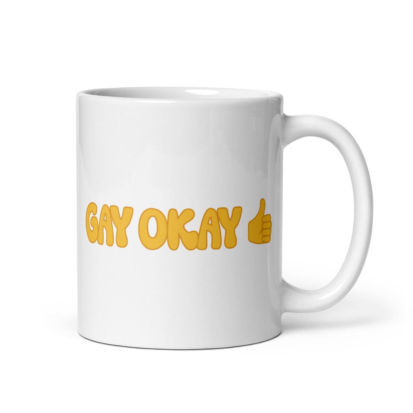 The "Gay Okay Mug" by Pridelity features bold yellow letters spelling "GAY OKAY" on a white coffee mug, complete with a thumbs-up emoji—it's a standout piece from the best pride collections of 2025.