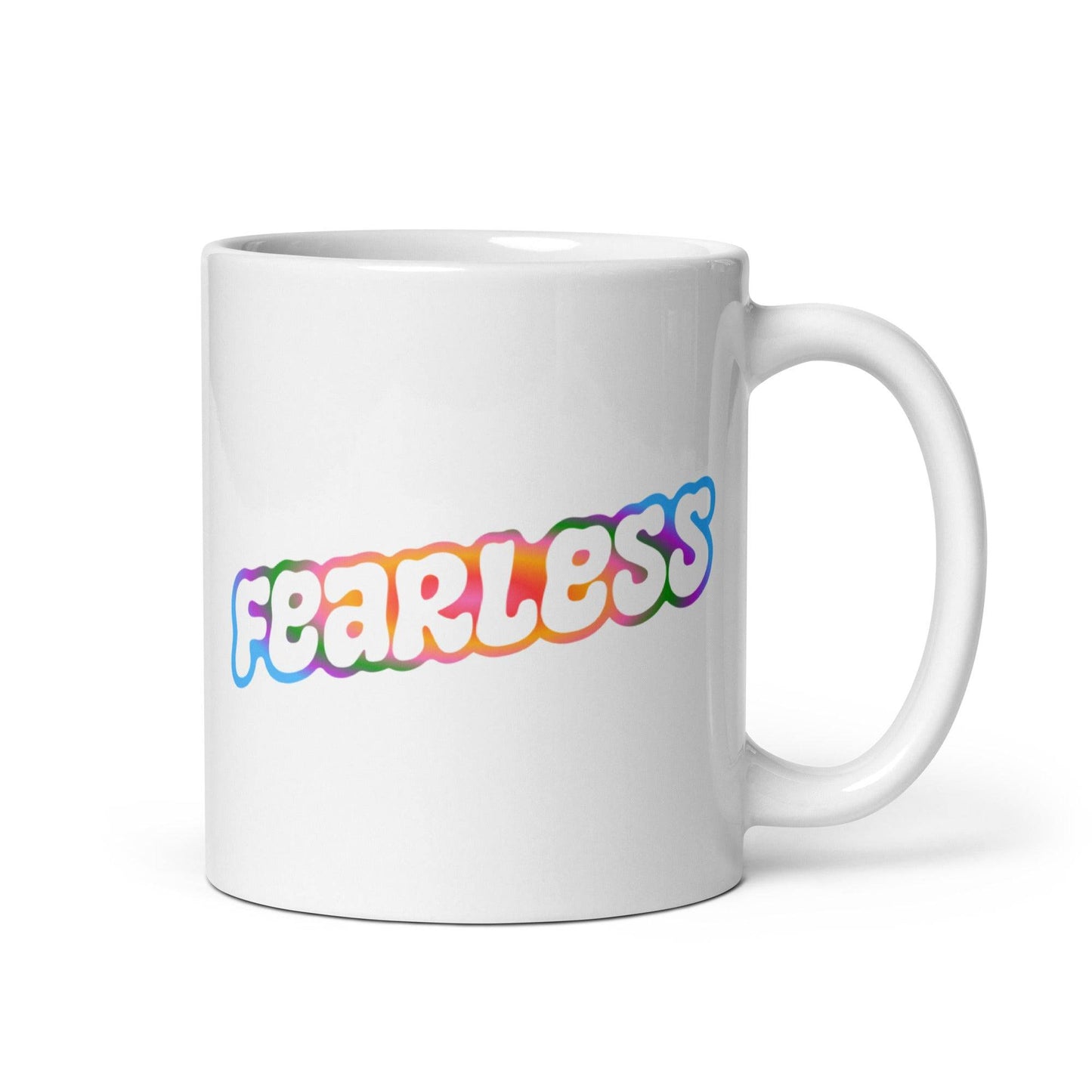 Introducing the Fearless Mug by Pridelity: a striking white mug featuring the word "fearless" in bubble-style letters, accented with a vibrant gradient of pink, orange, yellow, and blue. Part of the standout best pride collections for 2025, this mug offers a simple yet impactful design.