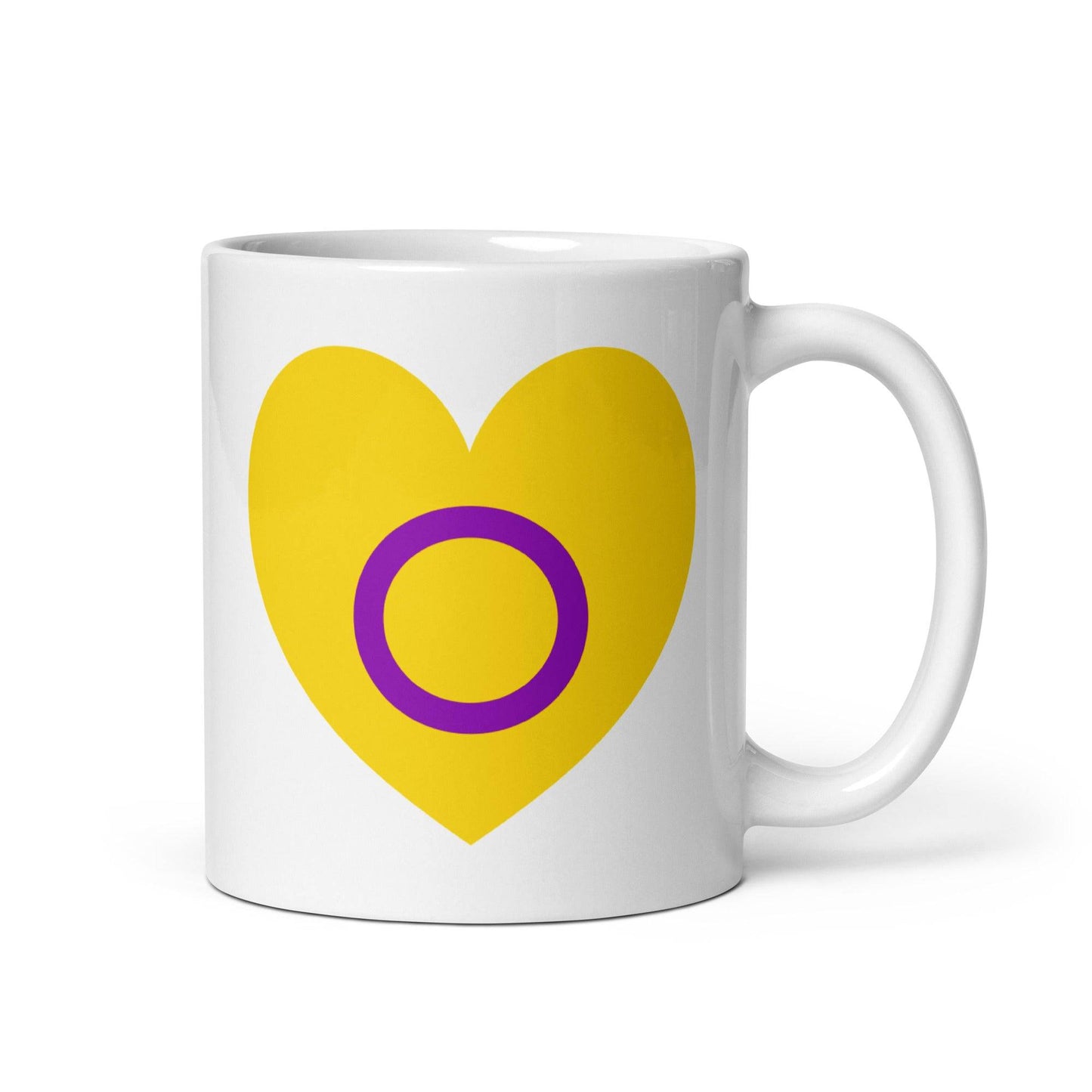 Introducing the Intersex Heart Mug from Pridelity's renowned 2025 pride collection. This white mug features a vibrant yellow heart with a purple circle at its center, and its elegantly placed handle on the right side adds to its charm.