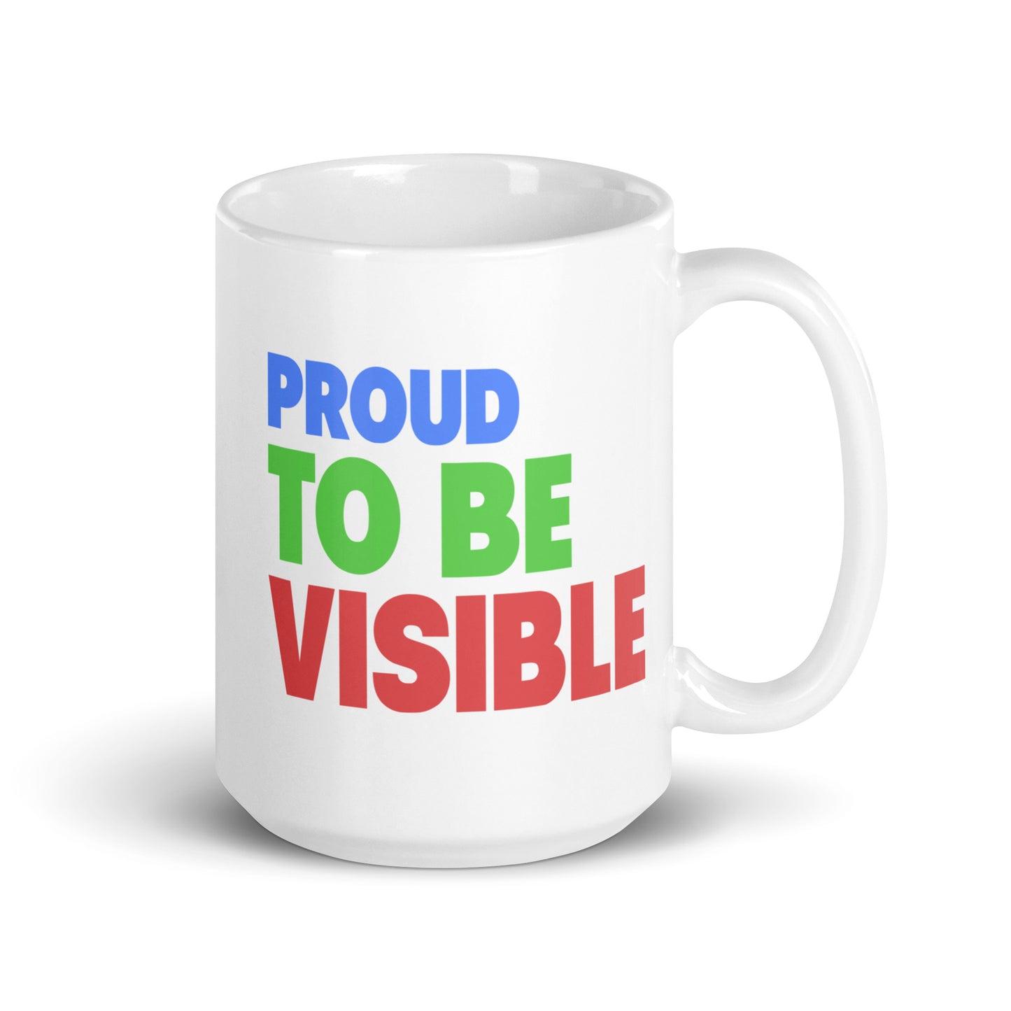 The Proud To Be Visible Mug from Pridelity's Pride Collections 2025 series showcases the phrase "Proud to Be Visible" in striking, colorful letters: "Proud" in blue, "To Be" in green, and "Visible" in red.