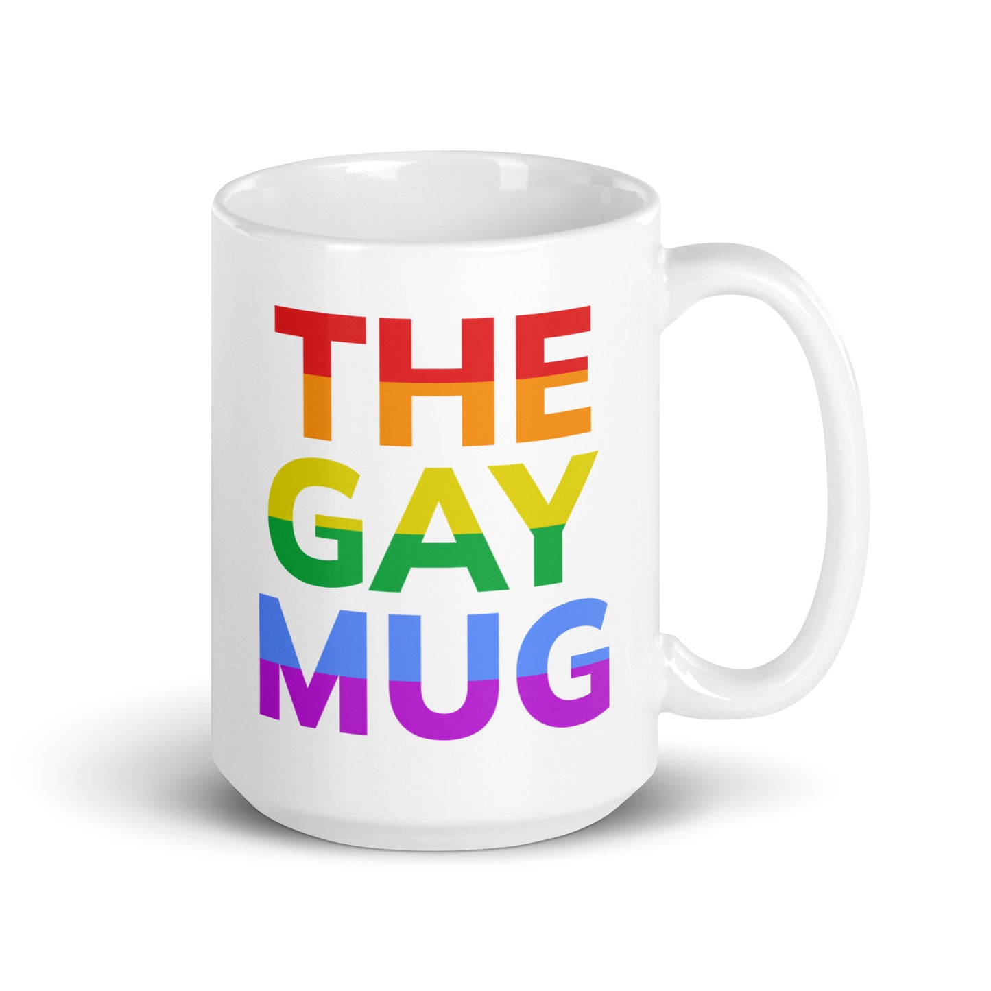 A product from Pridelity, The Gay Mug, is a white mug from the Pride Collections 2025 series featuring "THE GAY MUG" in bold letters. Each word radiates in a different shade of the LGBTQ+ pride rainbow: red, orange, yellow, green, blue, and purple.