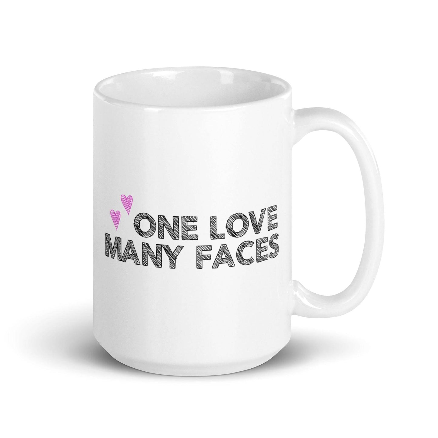 The One Love Many Faces Mug by Pridelity, part of the Pride Collections 2025, showcases the phrase "One Love Many Faces" in bold black letters. It is adorned with two small pink hearts on the left side above the text, all set against a plain white background to celebrate unity and diversity.