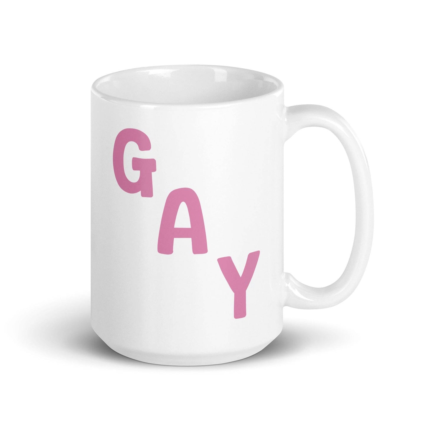 This mug by Pridelity, from the best pride collections of 2025, showcases the word "GAY" in bold pink capital letters, arranged diagonally on a white surface.