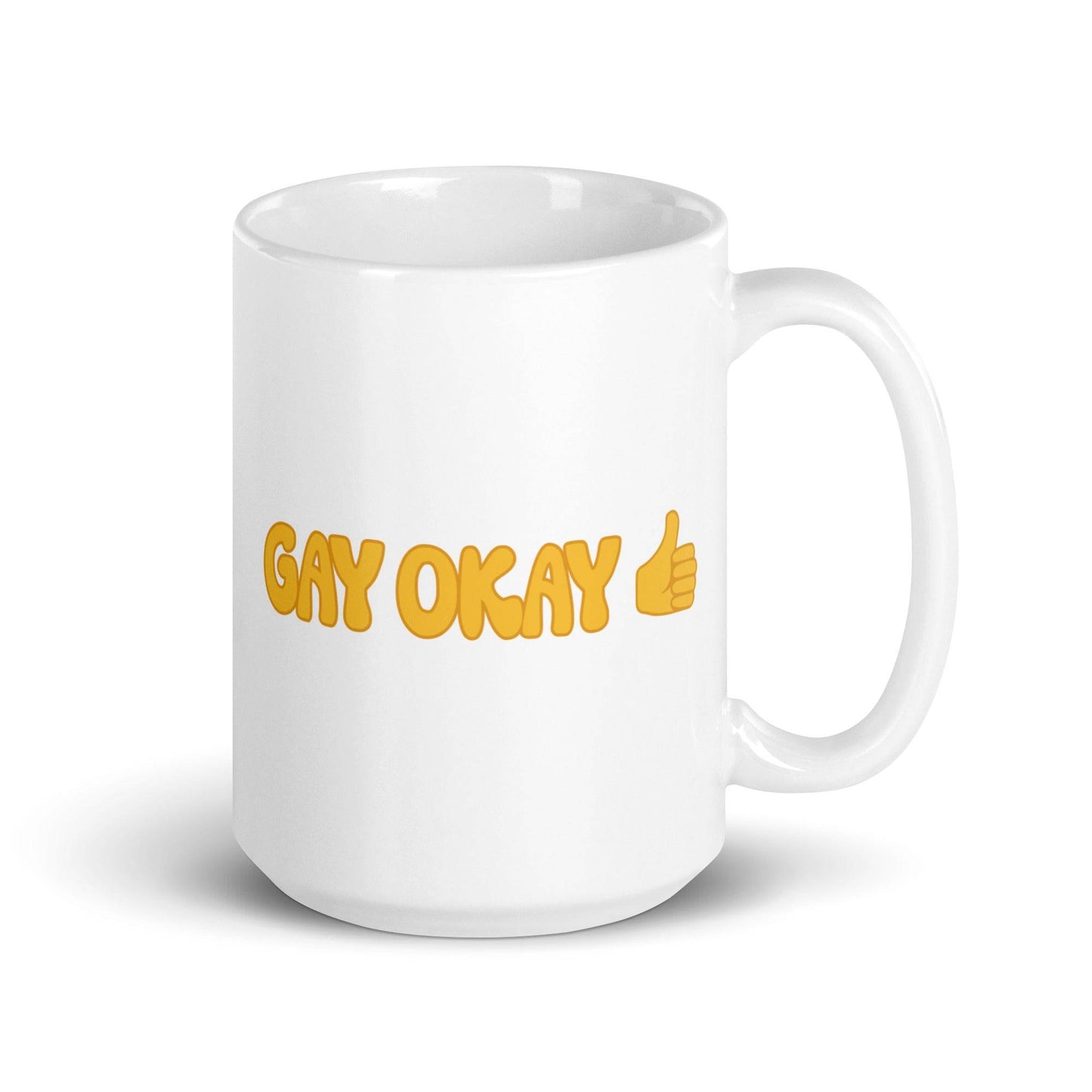 The "Gay Okay Mug" by Pridelity features bold yellow letters spelling "GAY OKAY" on a white coffee mug, complete with a thumbs-up emoji—it's a standout piece from the best pride collections of 2025.