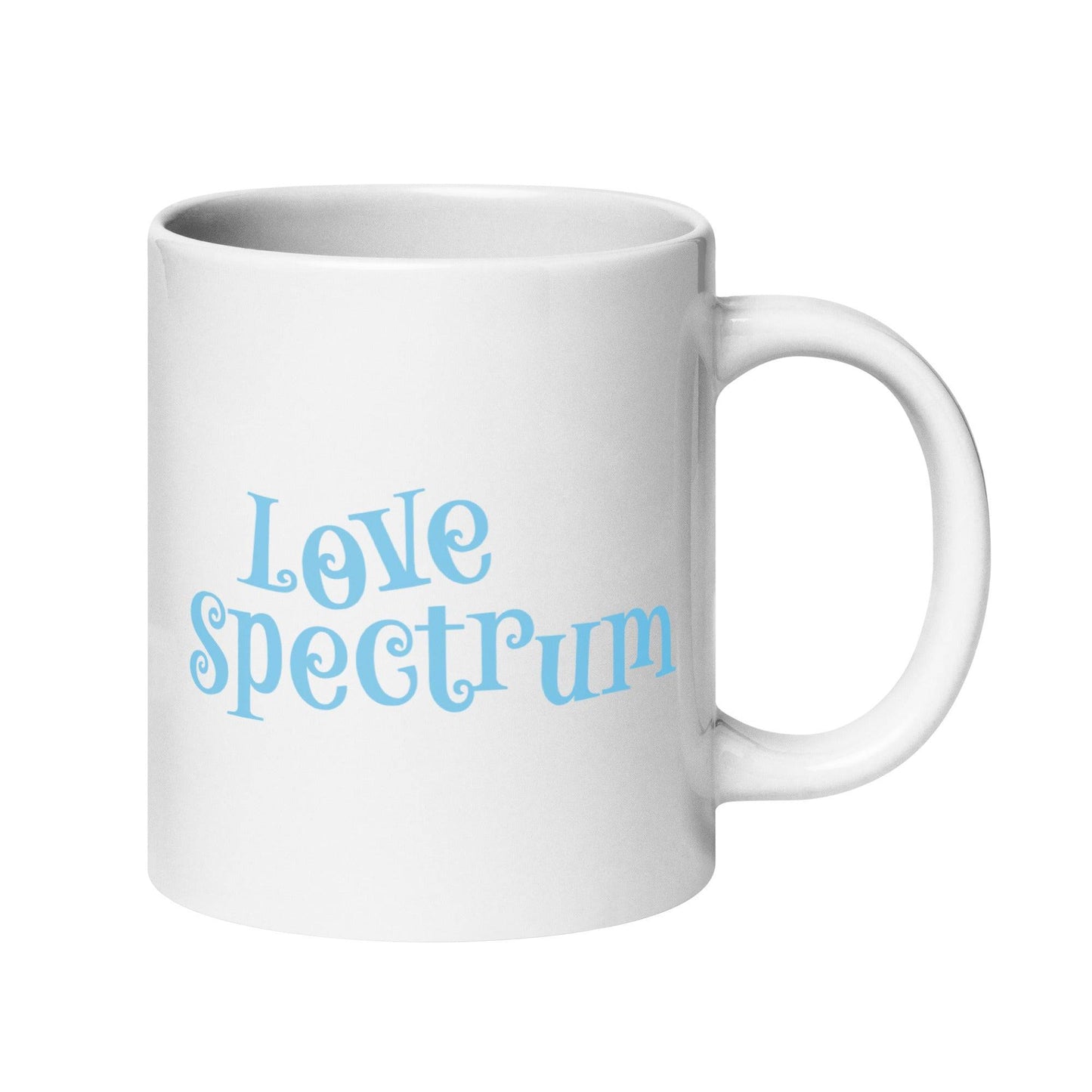 A white coffee mug featuring "Love Spectrum" in light blue, playful letters on one side is part of Pridelity's pride collection for 2025 and showcases a simple and clean design.