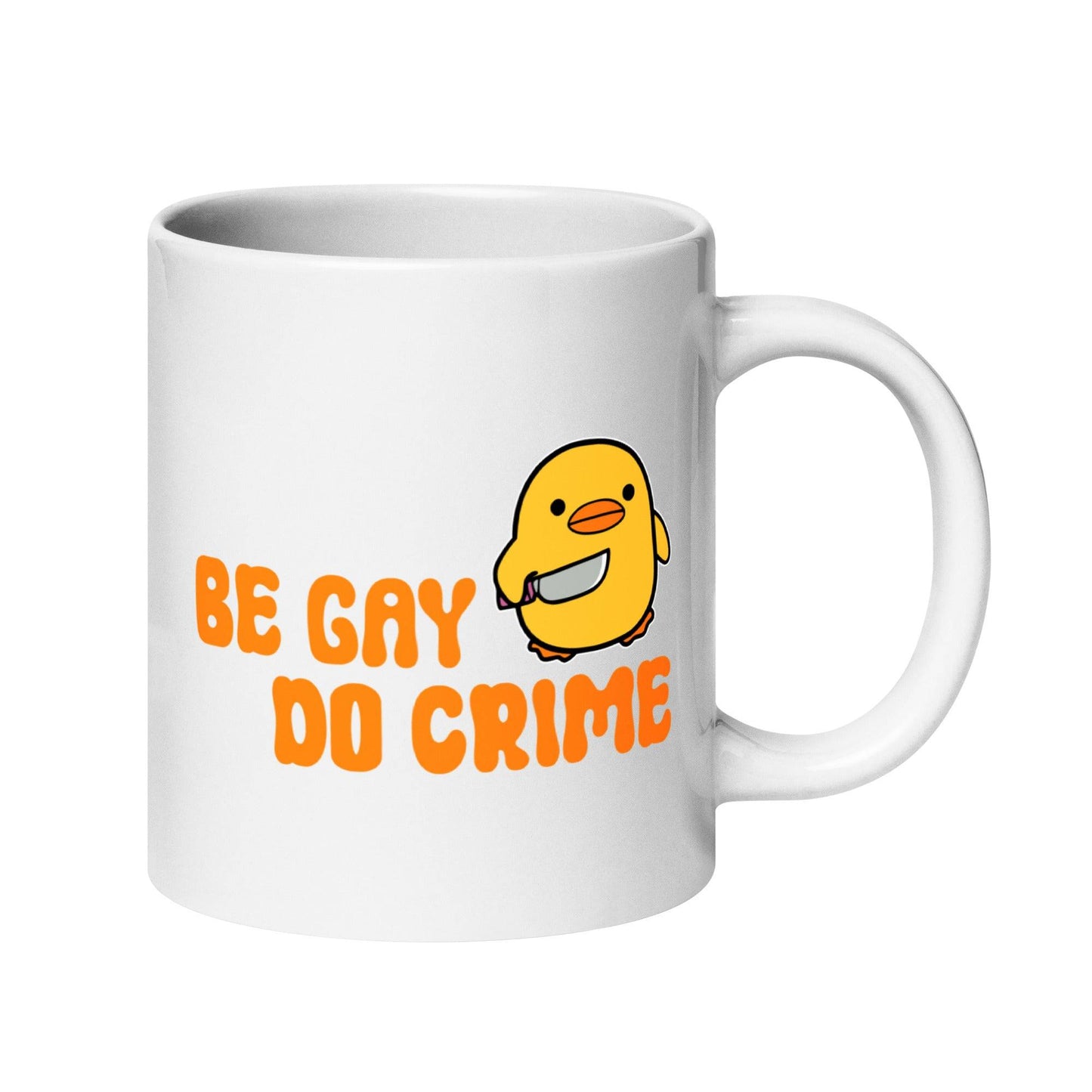 This white mug from Pridelity's Be Gay Do Crime collection showcases a cute yellow duck holding a knife, accompanied by bold orange text reading "Be Gay Do Crime.