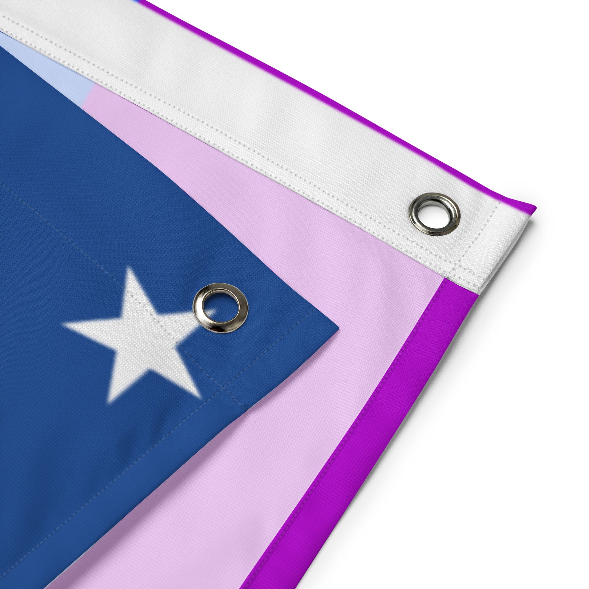 The Pride Stars and Stripes Flag from Pridelity, featuring an American flag seamlessly merged with the vibrant rainbow stripes of the LGBTQ+ pride flag, hangs against a white brick wall. Its stars on a blue background in the top left beautifully contrast with the horizontal rainbow stripes, creating an inviting and colorful display.