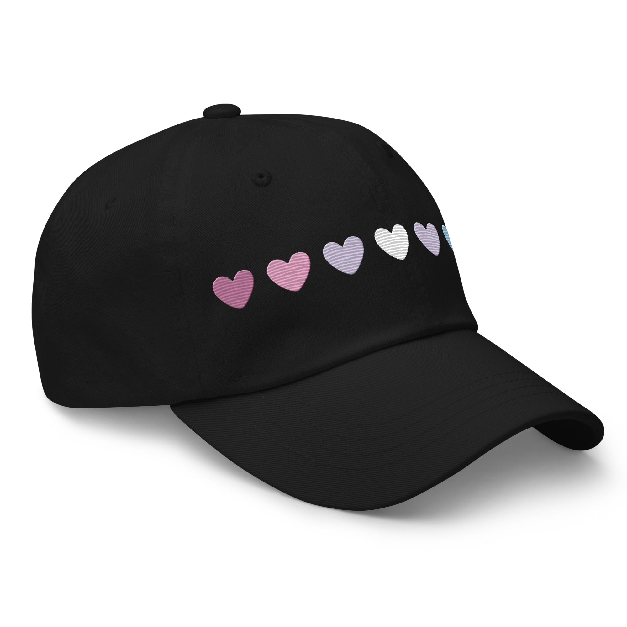 The Pridelity Bigender Hearts Cap, part of our Pride Collection, showcases a row of seven gradient heart symbols transitioning in color from pink to white to blue on a black base.