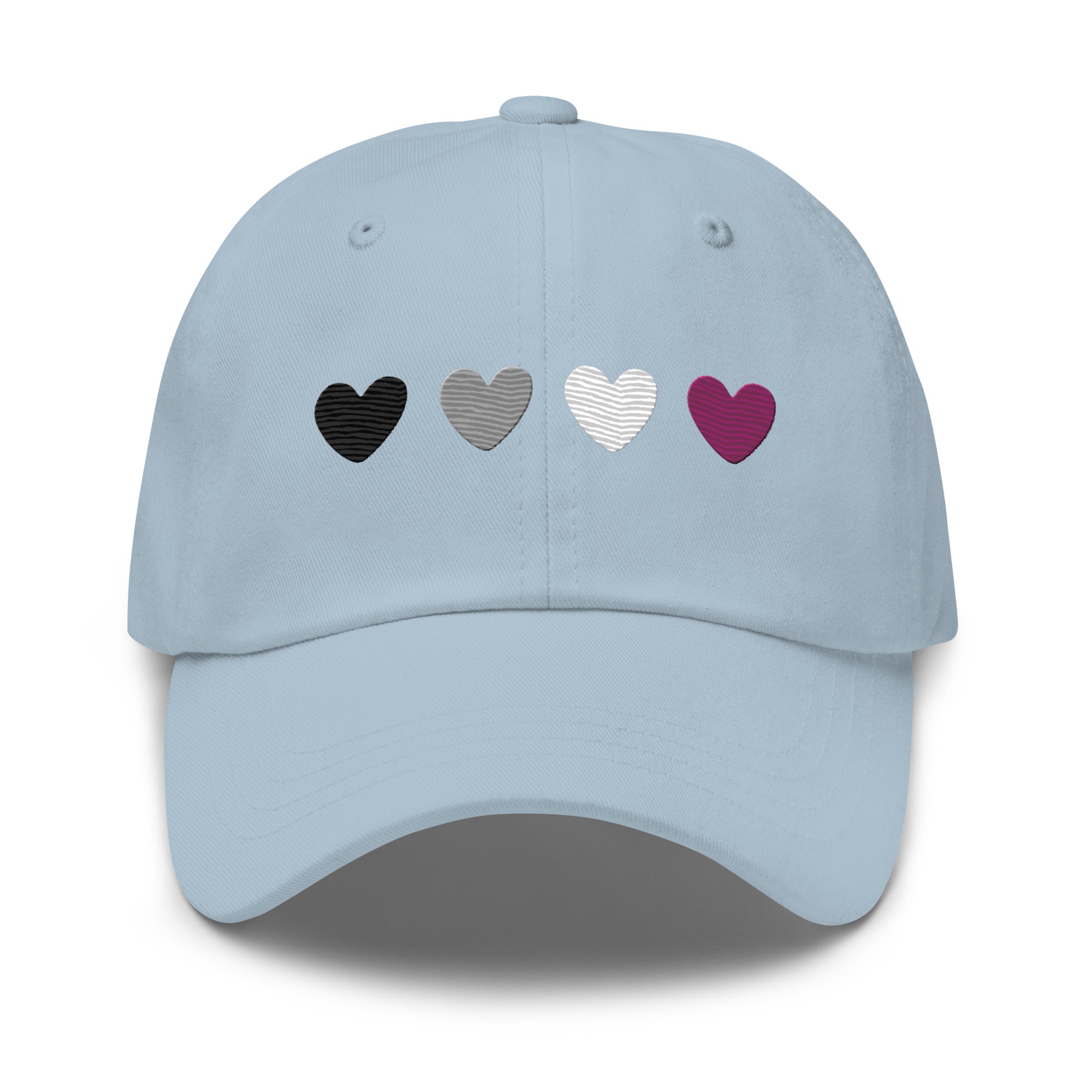 Introducing the Asexual Hearts Cap from Pridelity's Pride Collections, this pink baseball cap proudly displays four hearts in black, gray, white, and purple to represent the asexual flag.