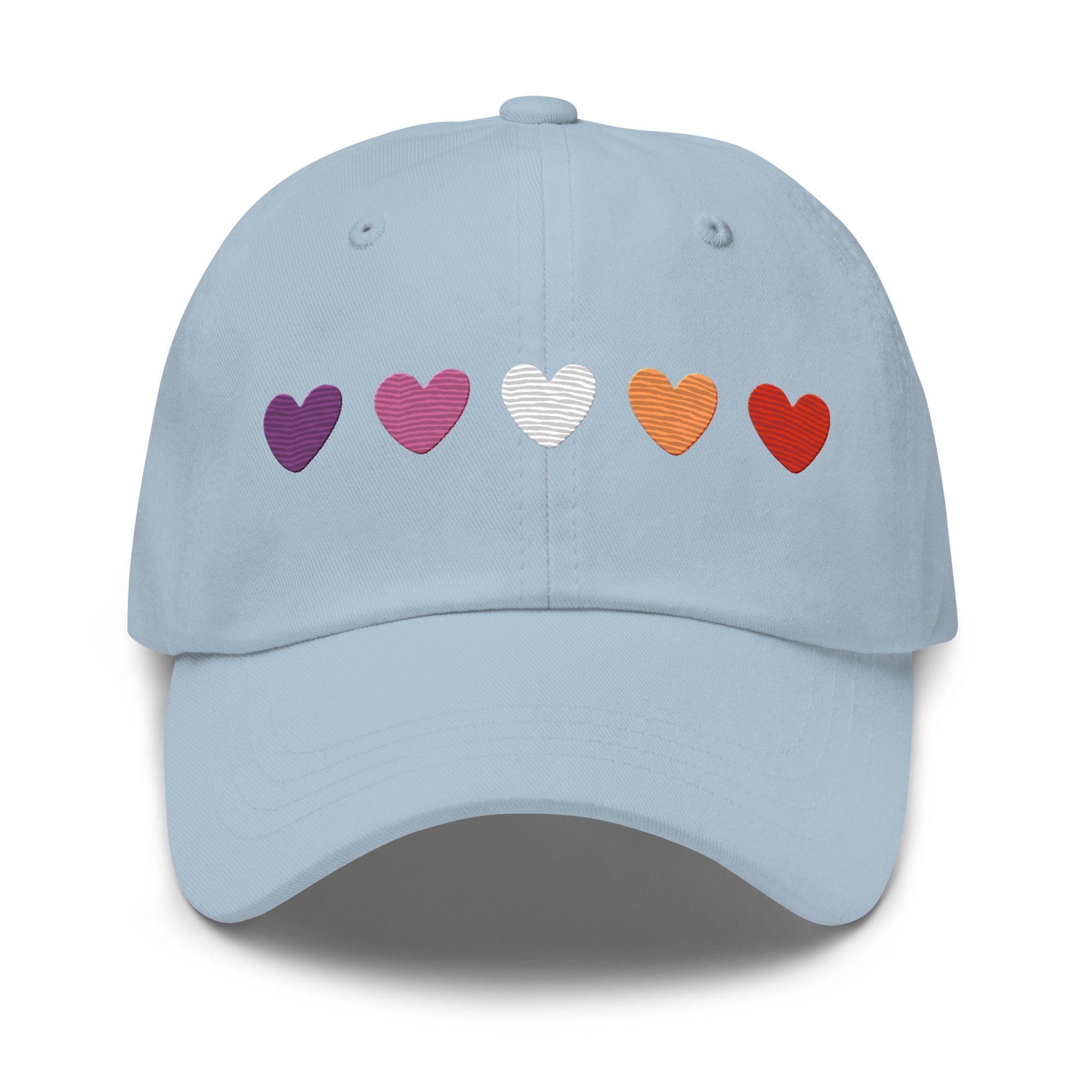 The Pridelity Lesbian Hearts Cap, in a vibrant pink hue, enhances pride outfits with its five embroidered hearts in shades of purple, lavender, white, orange, and red. Set against a plain background, this cap is the perfect accessory to celebrate love and diversity.