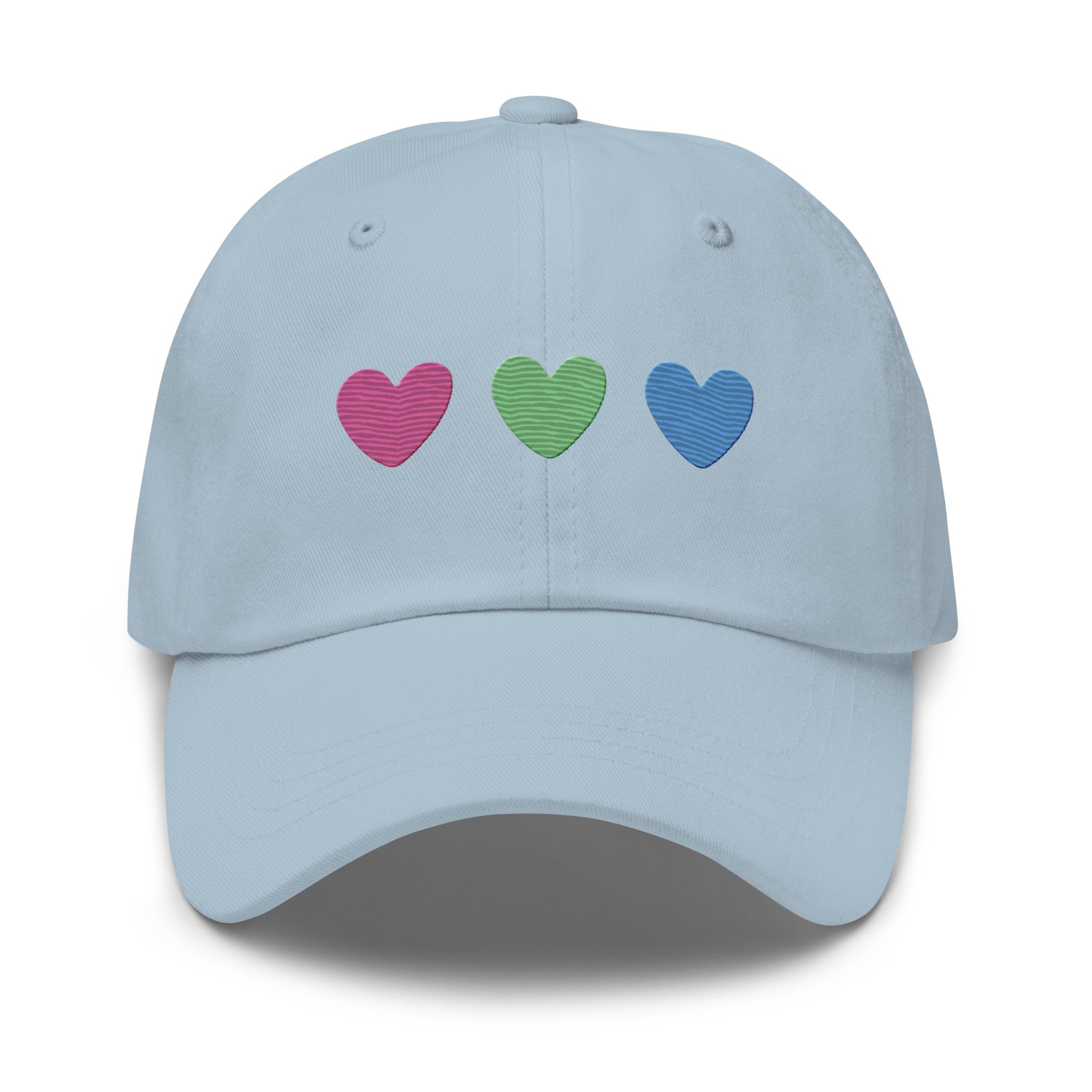 The Polysexual Hearts Cap by Pridelity is a black baseball cap ideal for pride outfits, featuring three embroidered hearts in pink, green, and blue arranged in a row on the front.