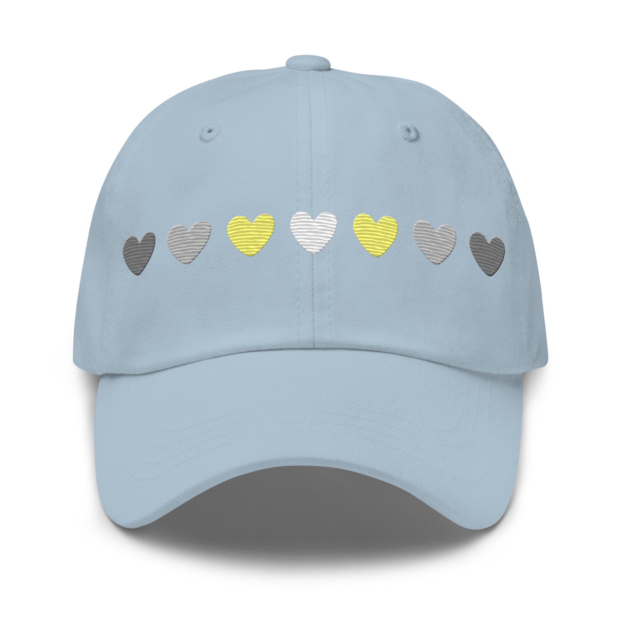 Introducing the Demigender Hearts Cap by Pridelity, a stylish black baseball cap ideal for pride outfits. It features a row of hearts embroidered on the front, transitioning seamlessly from gray on the left to vibrant yellow in the center, and back to gray on the right.