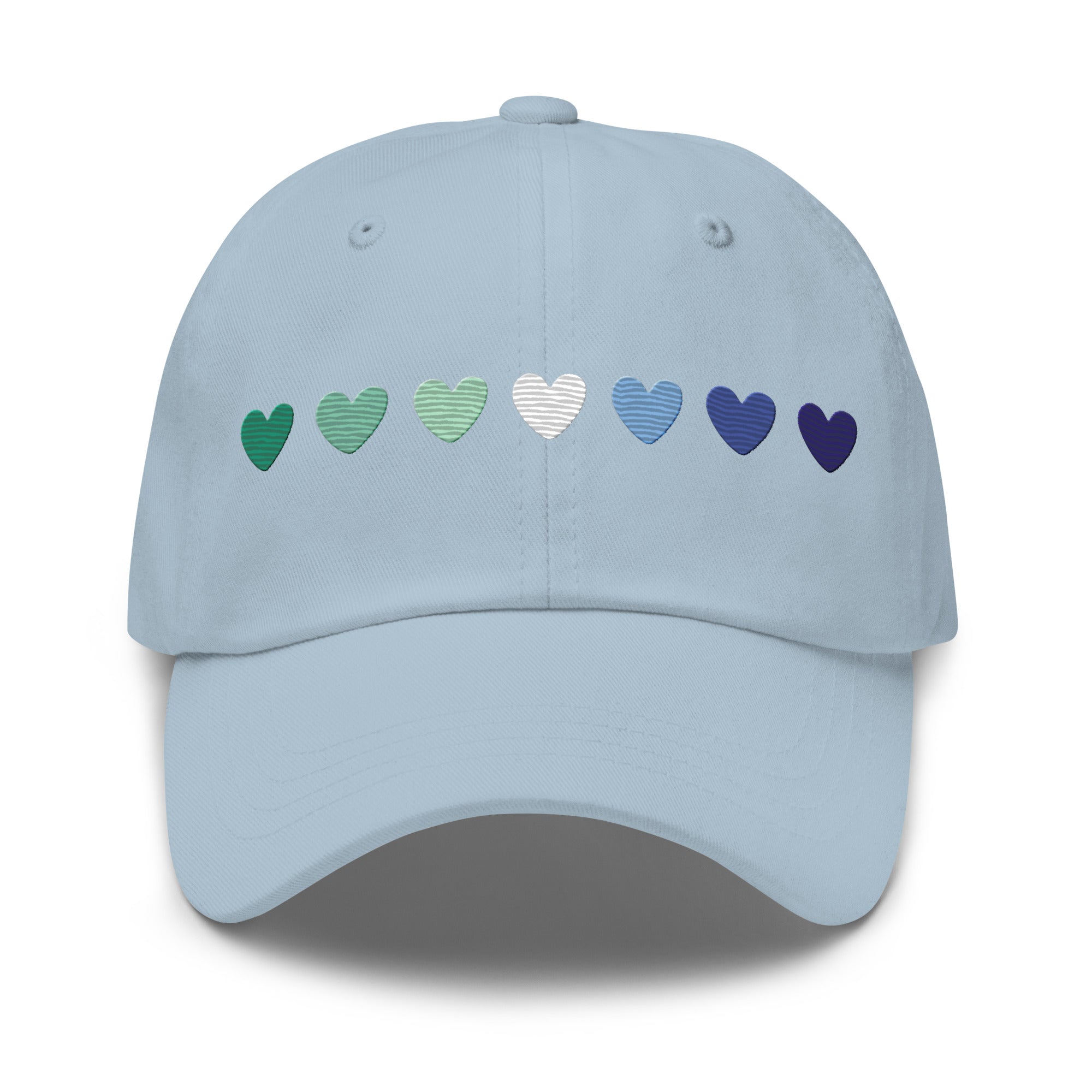 The Gay Men Hearts Cap by Pridelity is a black cap adorned with a row of seven hearts in gradient colors from green to blue, making it an ideal accessory for adding a subtle yet vibrant touch to pride outfits.