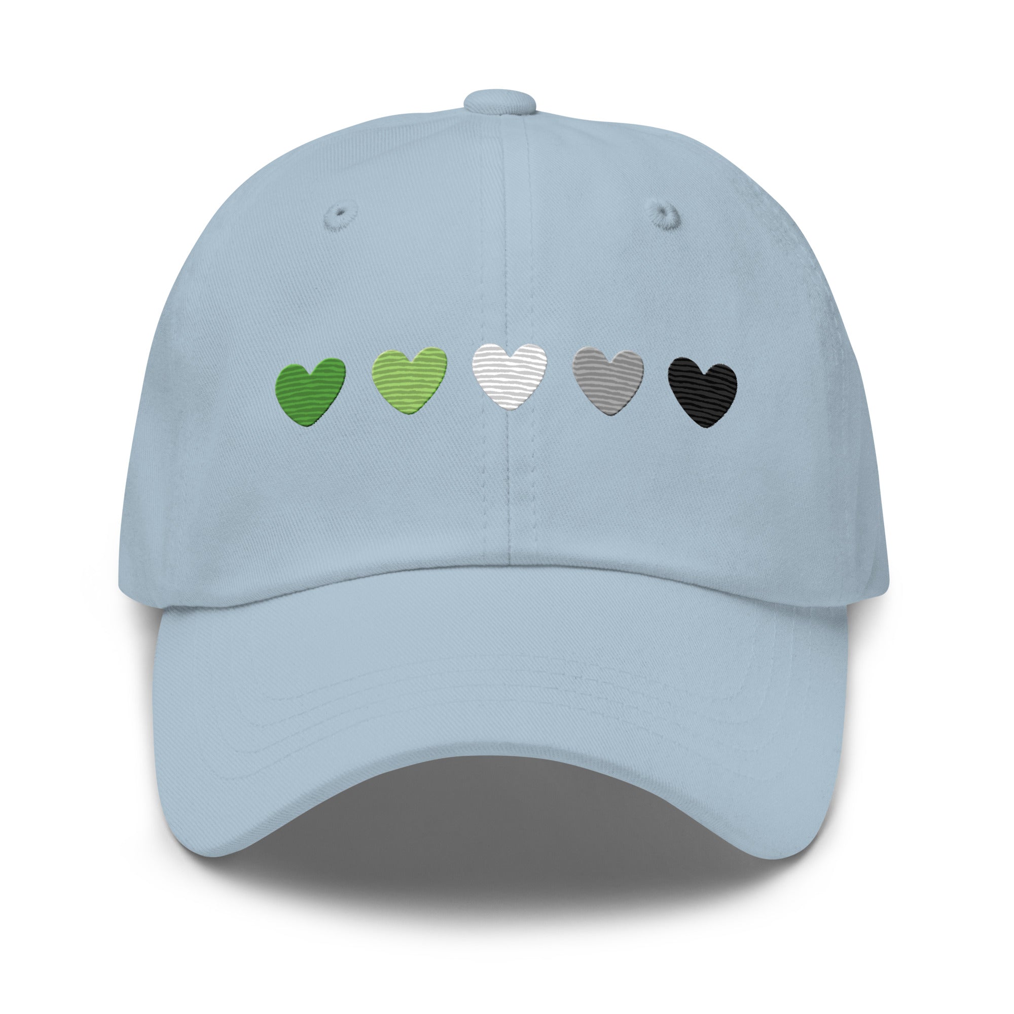 The Aromantic Hearts Cap by Pridelity, part of the Pride Collection, is a beige baseball cap featuring five hearts in a row colored dark green, light green, white, gray, and black to represent the aromantic pride flag.