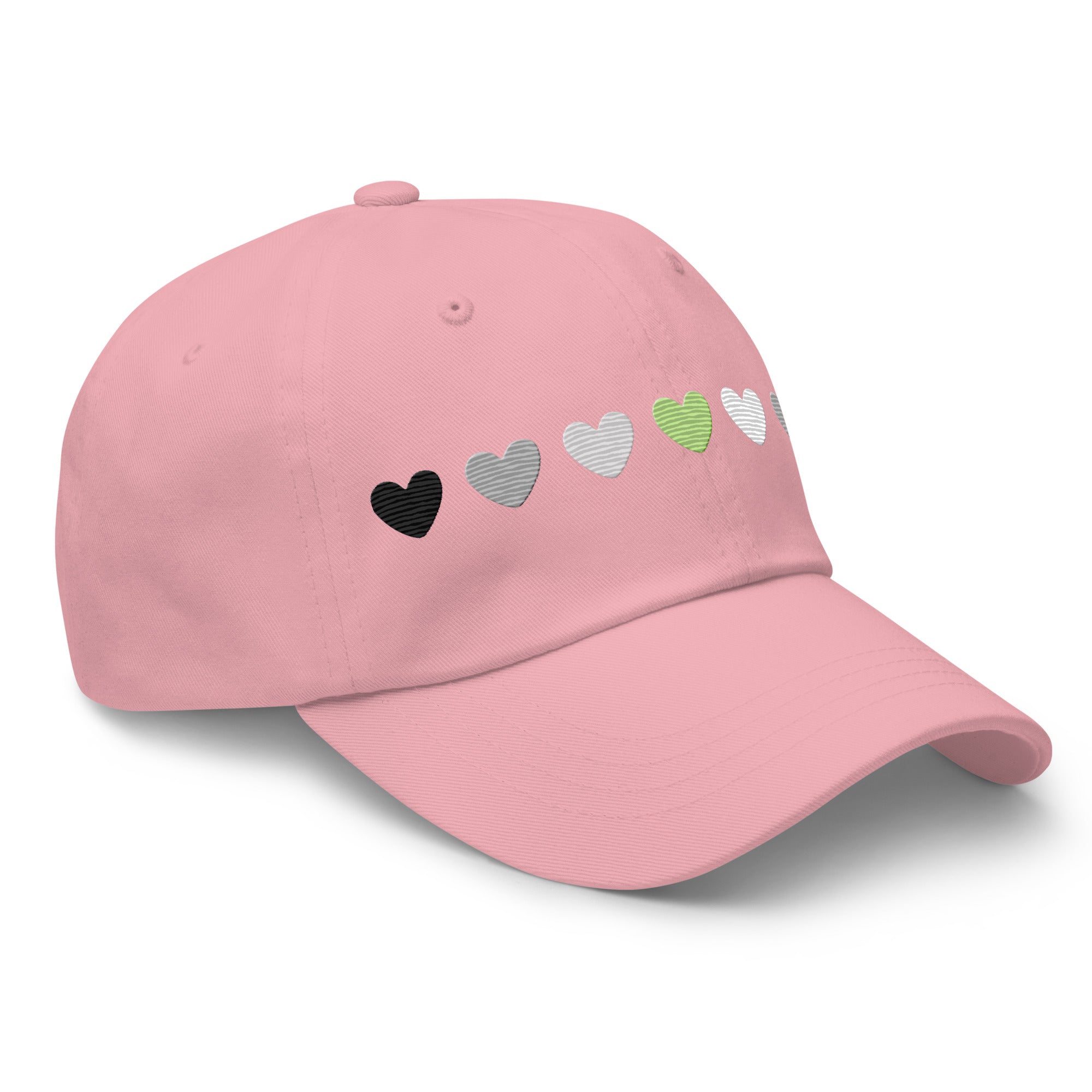 Introducing the Agender Hearts Cap by Pridelity: a pink baseball cap made from Chino cotton twill, showcasing a row of seven heart shapes in the aromantic flag colors—dark green, light green, white, gray, and black. It’s a classic hat featuring a vintage buckle for adjustable comfort.