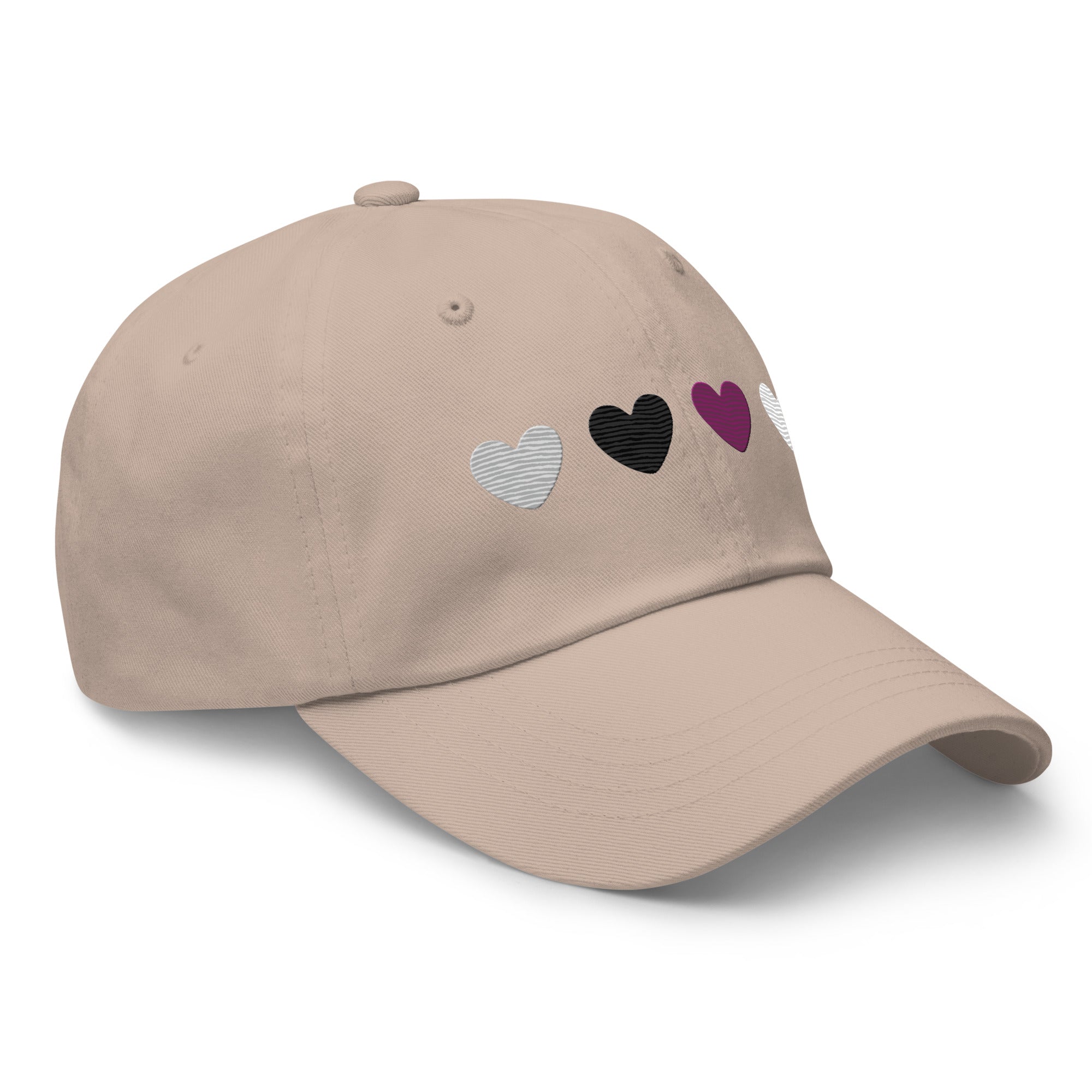 The Demisexual Hearts Cap from Pridelity, featuring four heart symbols in silver, black, purple, and white on a stone base, seamlessly complements pride outfits.