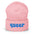 The Queer Beanie by Pridelity, in a delightful baby pink with the word "queer" emblazoned in playful blue bold letters on the front, is a standout piece of gay clothing.