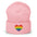 A black Heart Beanie by Pridelity, adorned with a rainbow-striped heart emblem representing the spirit of gay clothing, is showcased against a plain white background. The vibrant heart signifies diversity and inclusion.