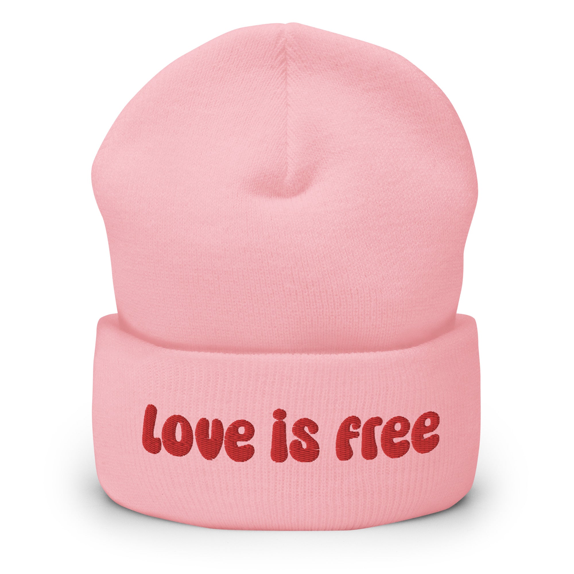 The Love Is Free Beanie by Pridelity is a baby pink accessory that boldly features the phrase 