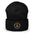 The Pridelity Peace Beanie, in black, showcases a vibrant rainbow-colored peace symbol on the front, making it the perfect accessory to add a touch of pride to any outfit. It is elegantly displayed against a plain white background.