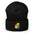 The Pride Duck Beanie by Pridelity, a striking piece of gay clothing, showcases an embroidered rubber duck with a rainbow pattern on its body, located on the cuff. This gold beanie features a folded brim and a rounded top.