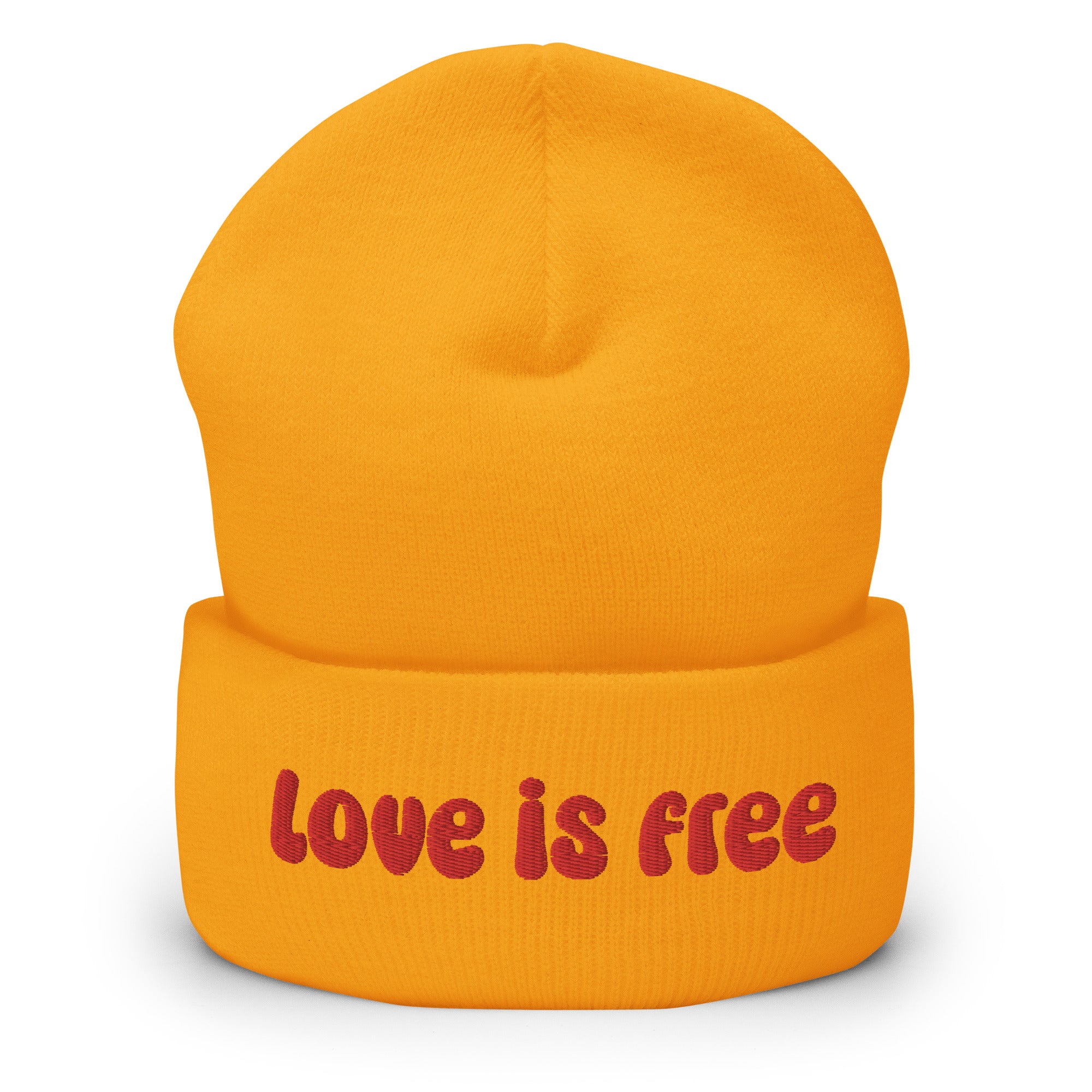 The Love Is Free Beanie by Pridelity is a baby pink accessory that boldly features the phrase 