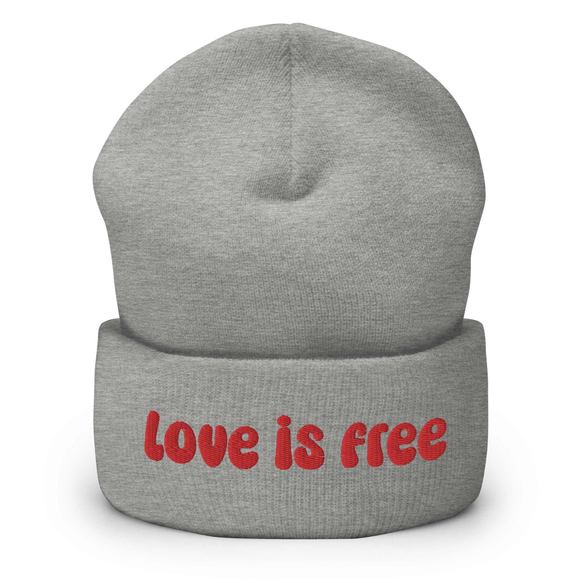 The Love Is Free Beanie by Pridelity is a baby pink accessory that boldly features the phrase 