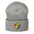 The Pride Duck Beanie by Pridelity, a striking piece of gay clothing, showcases an embroidered rubber duck with a rainbow pattern on its body, located on the cuff. This gold beanie features a folded brim and a rounded top.