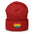 A black Heart Beanie by Pridelity, adorned with a rainbow-striped heart emblem representing the spirit of gay clothing, is showcased against a plain white background. The vibrant heart signifies diversity and inclusion.