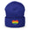 A black Heart Beanie by Pridelity, adorned with a rainbow-striped heart emblem representing the spirit of gay clothing, is showcased against a plain white background. The vibrant heart signifies diversity and inclusion.