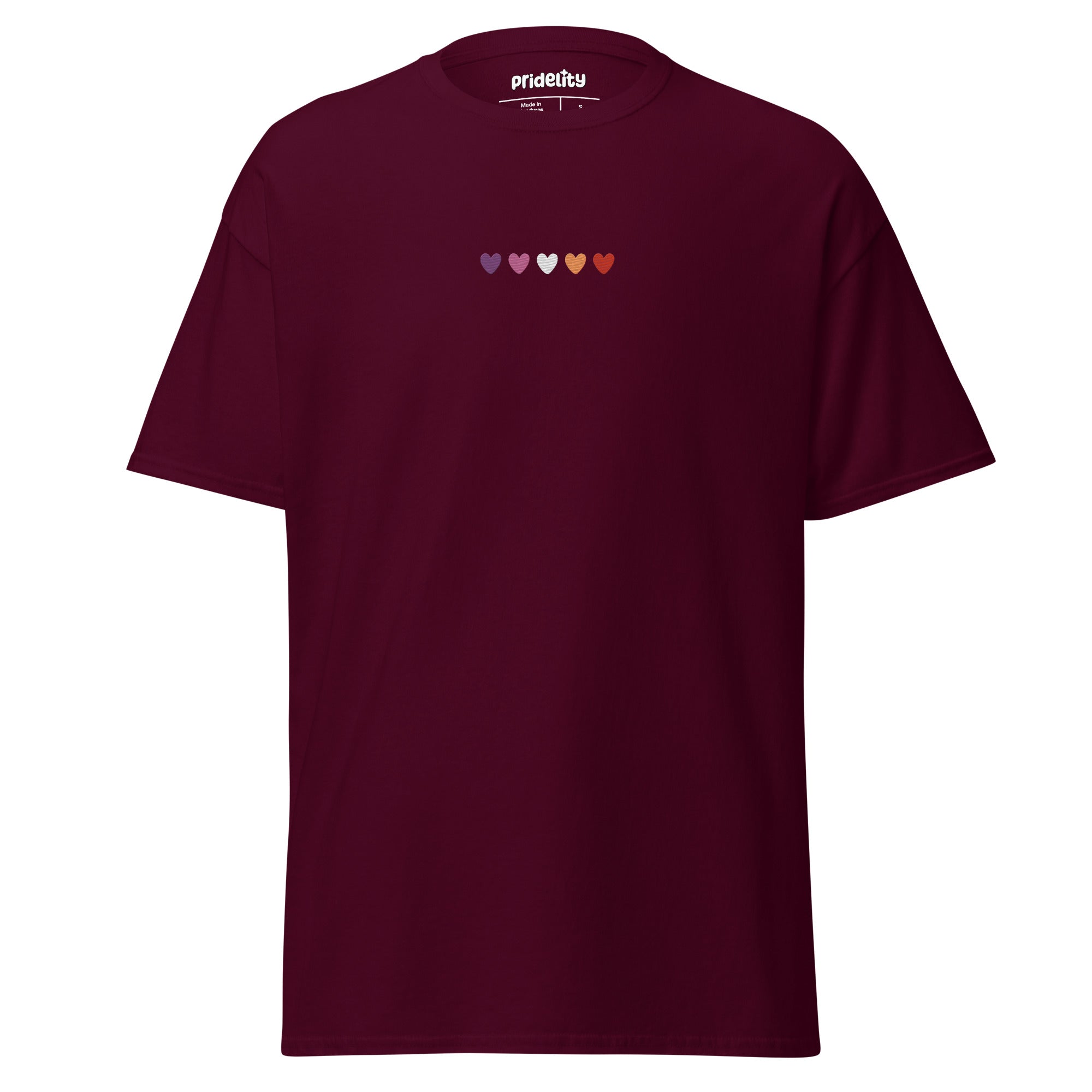 A maroon t-shirt called the Lesbian Love T-Shirt features six small hearts across the chest, each in different colors: purple, blue, teal, green, orange, and yellow. The brand name 