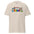 The Freedom T-Shirt by Pridelity features a colorful, cartoon-style design with "FREEDOM" in vibrant letters. A rainbow arches above clouds, flowers, and stars on the beige fabric, creating a whimsical and cheerful piece of pride merchandise.